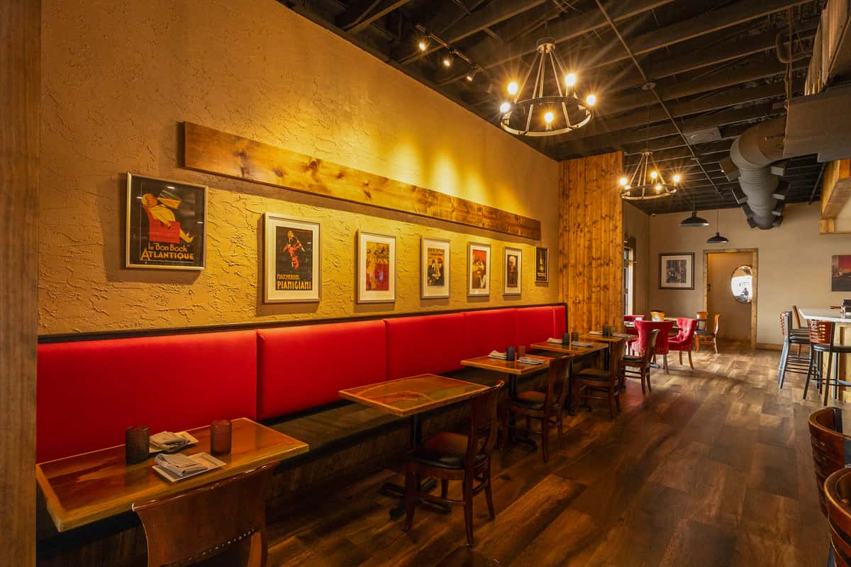 Red leather seating with warm lighting and wooden finishes