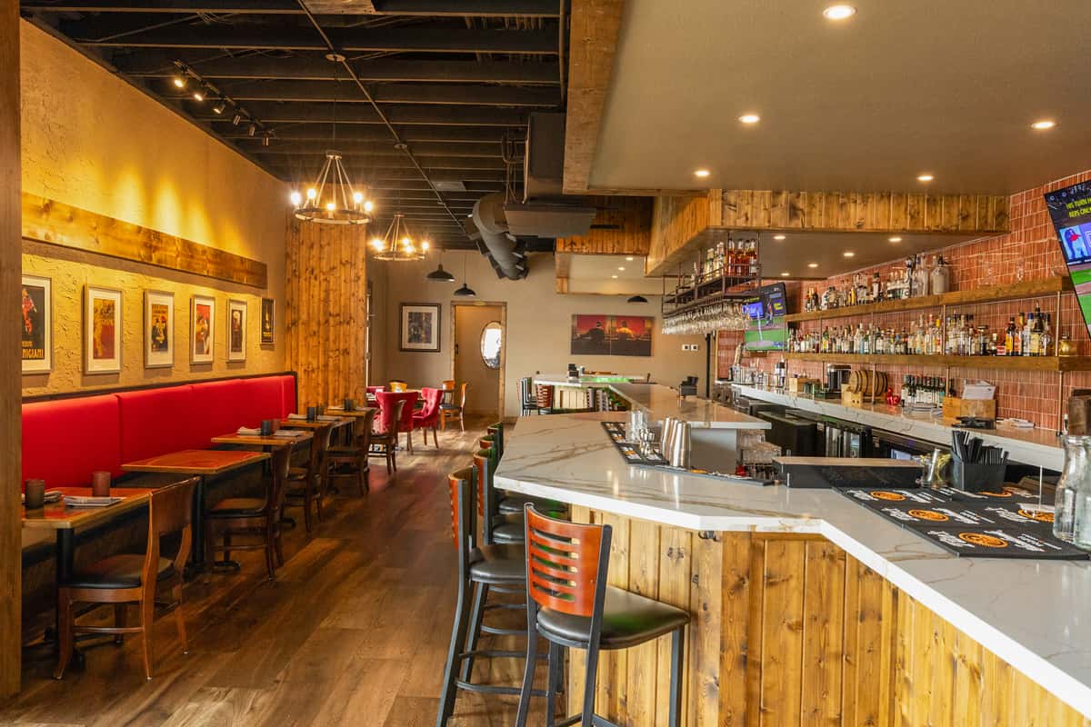 Interior bar and dining area with warm lighting and wood finishes