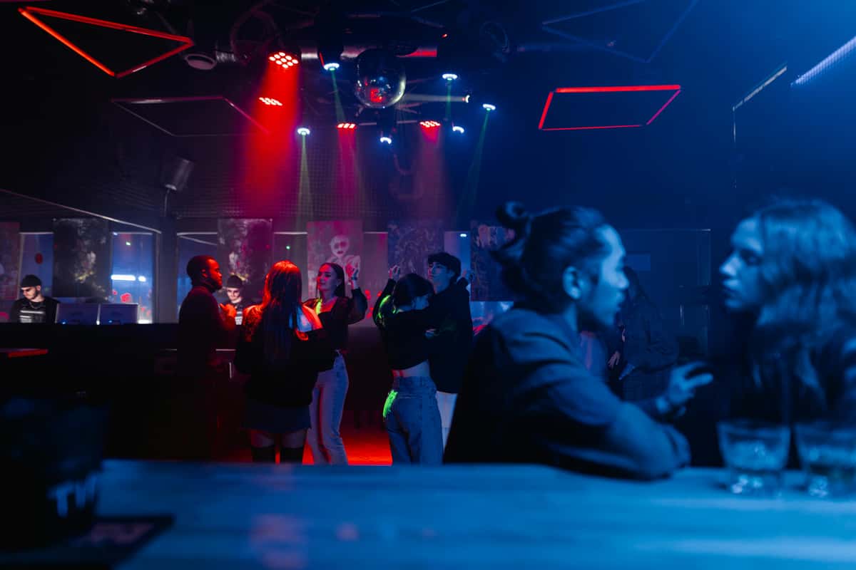 Lively pub scene with customers at a bar table at night
