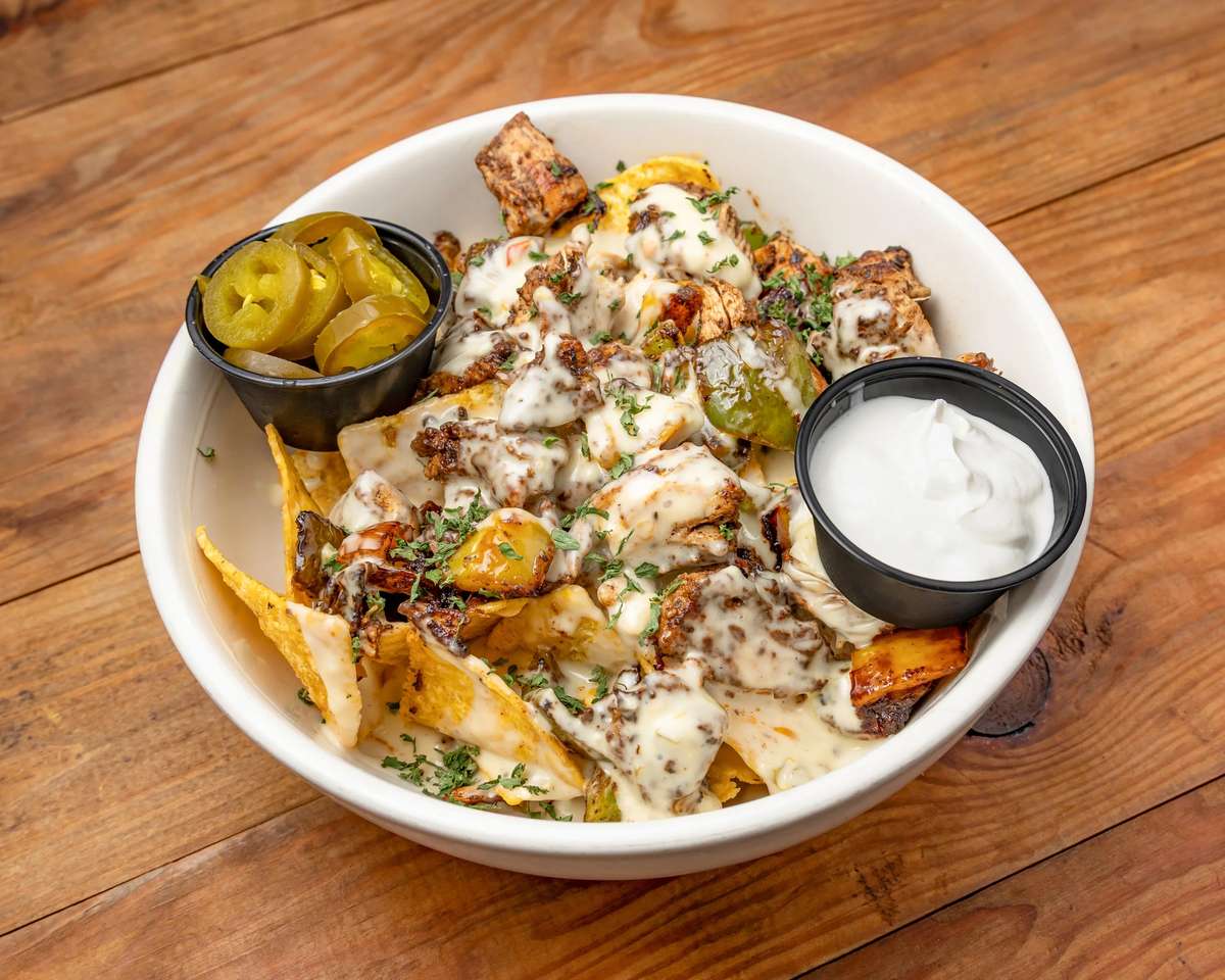 Chip and fries with sauce and pickle slices