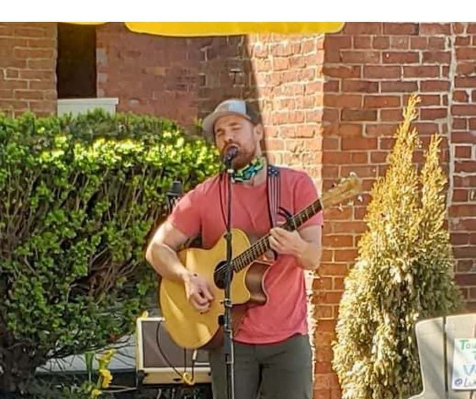 A man sings and plays guitar