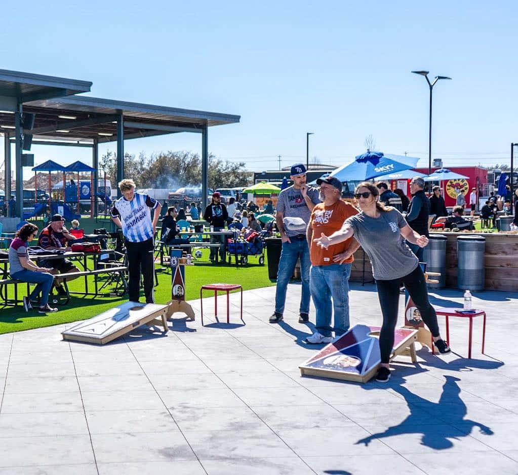 people playing cornhole