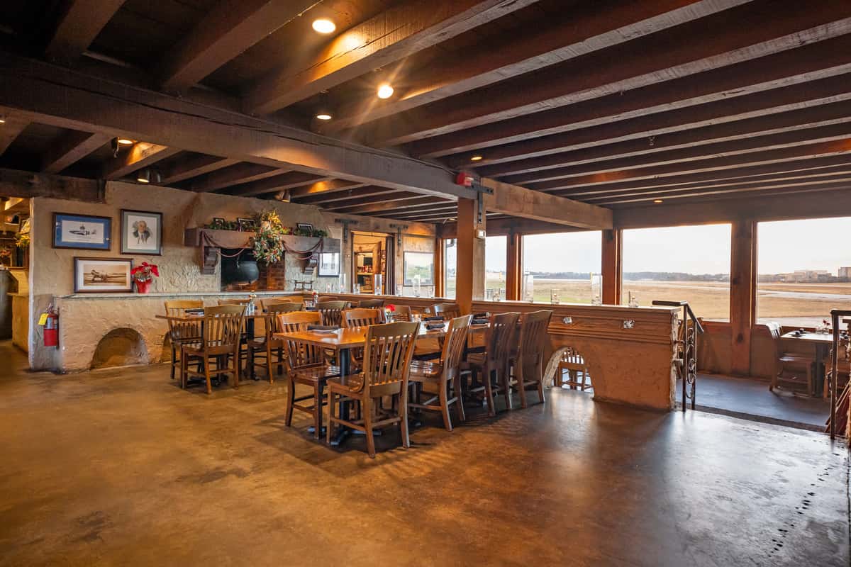 Tables overlooking the runway at The 57th Fighter Group Restaurant