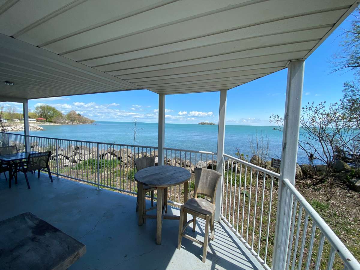 waterfront balcony with dining table and chair