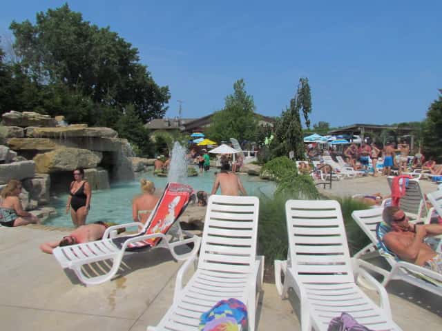 people hanging out by the pool and hanging out in lounge chairs