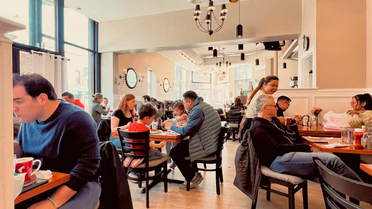 Guests dining by the windows at Lincoln Park Corner Kitchen