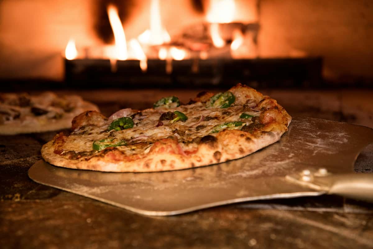 pizza from flaming oven