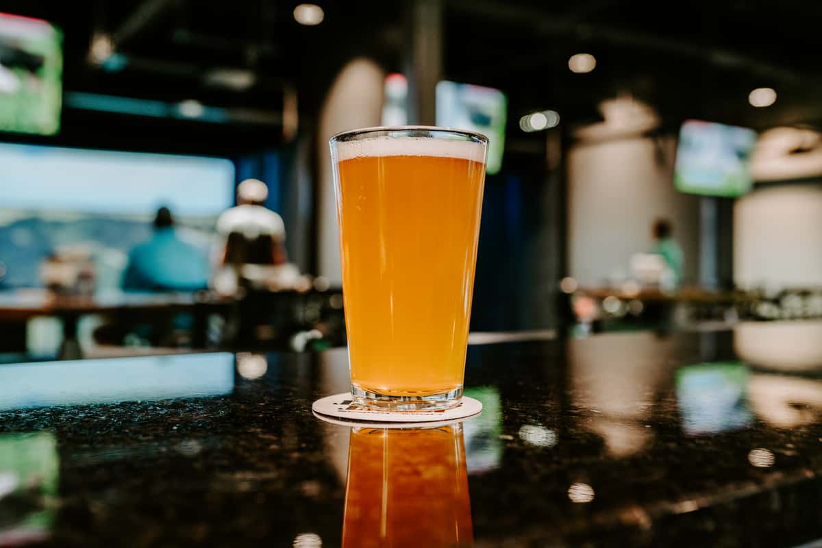 A drink displayed with a background of golfing customers