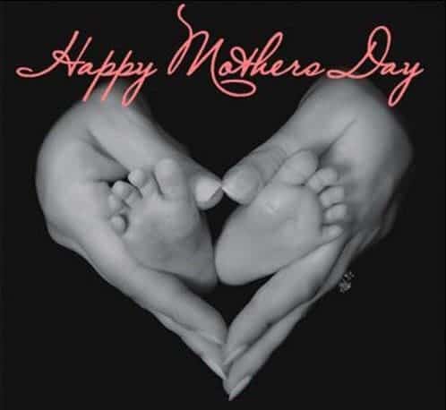 happy mother's day baby's feet in mother's hands
