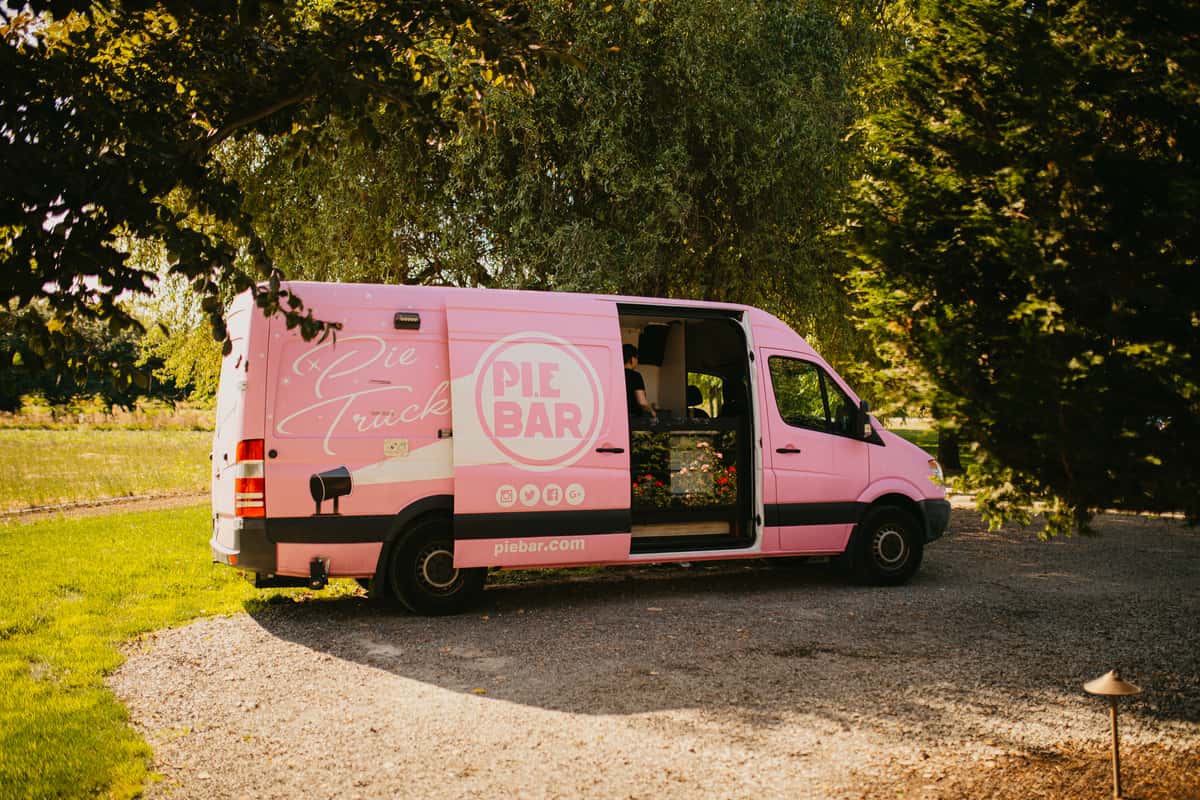 Image Description: Our cute pink truck at a summer wedding.