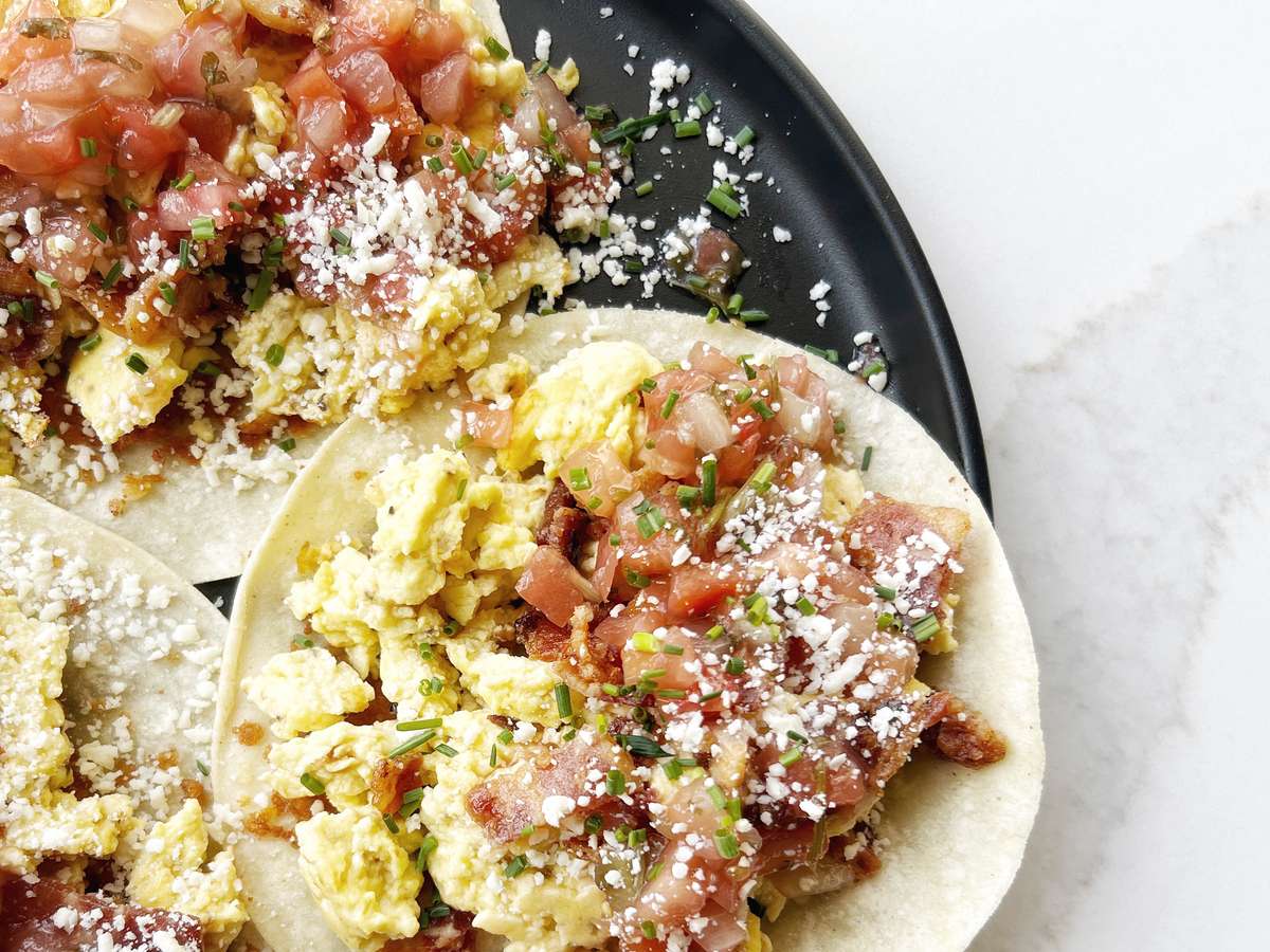three gluten-free corn tortillas, toasted with cotija, Harper Hill farm eggs, scrambled, house salsa, nitrate/nitrite free bacon, chives, and cotija