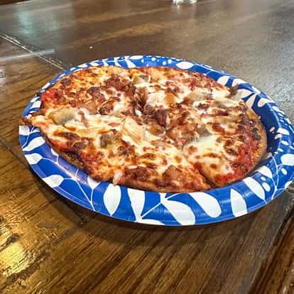 Thin-crust cheese pizza with golden melted mozzarella and rich tomato sauce served fresh on a restaurant table
