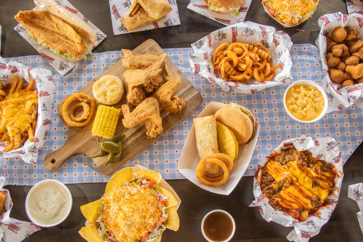 Texas Tom's spread of burgers, burritos, wings, fries, onion rings, and sides