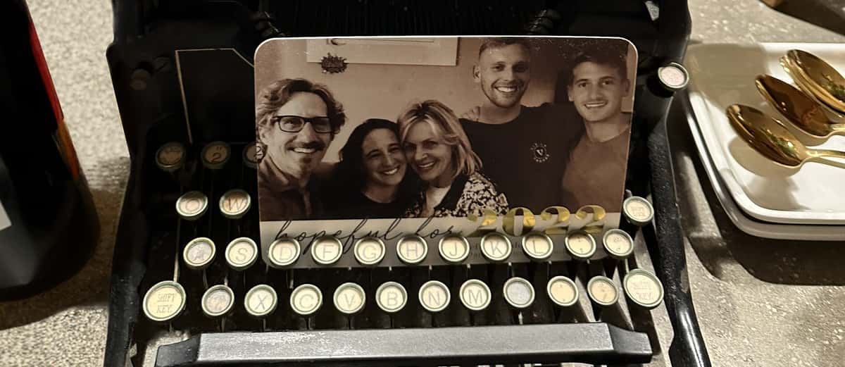 A typewriter with a picture of Maddys family placed on the keys