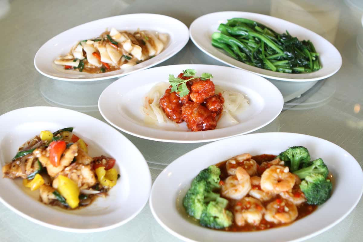 Assorted Chinese dishes including shrimp, chicken, and stir-fried vegetables