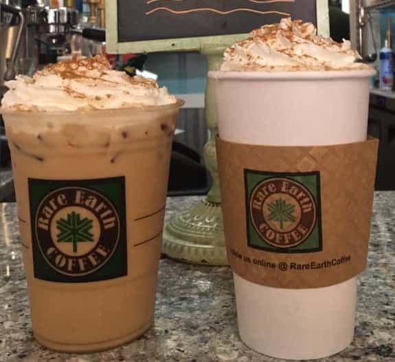 one hot and one cold coffee each topped with whipped cream