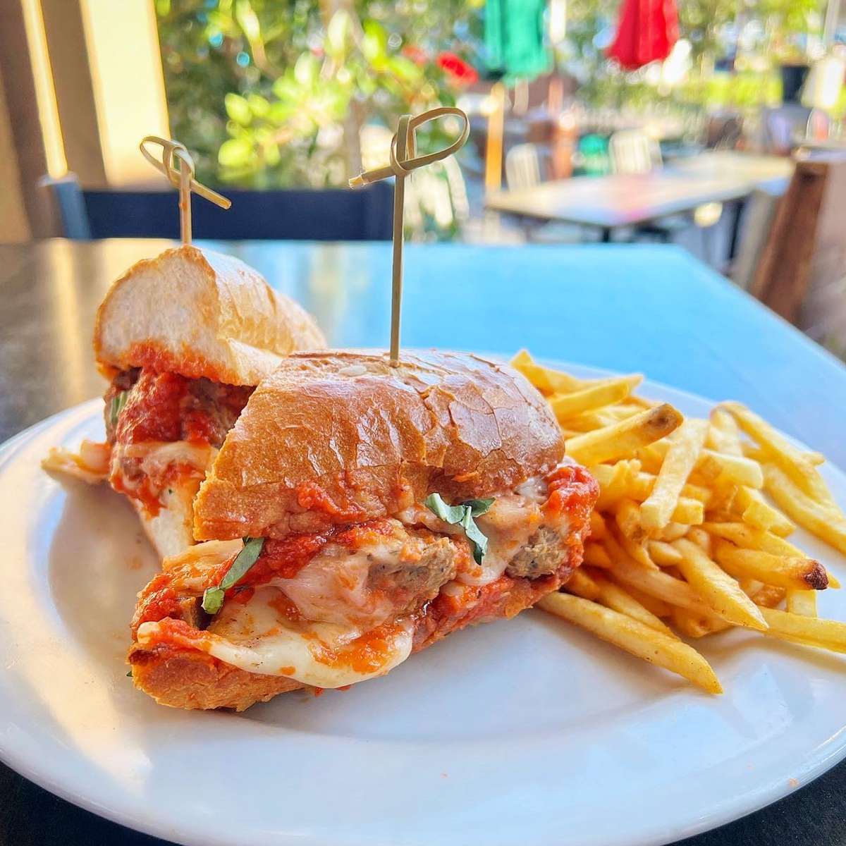 Crispy sandwich filled with a sauce and a side of fries