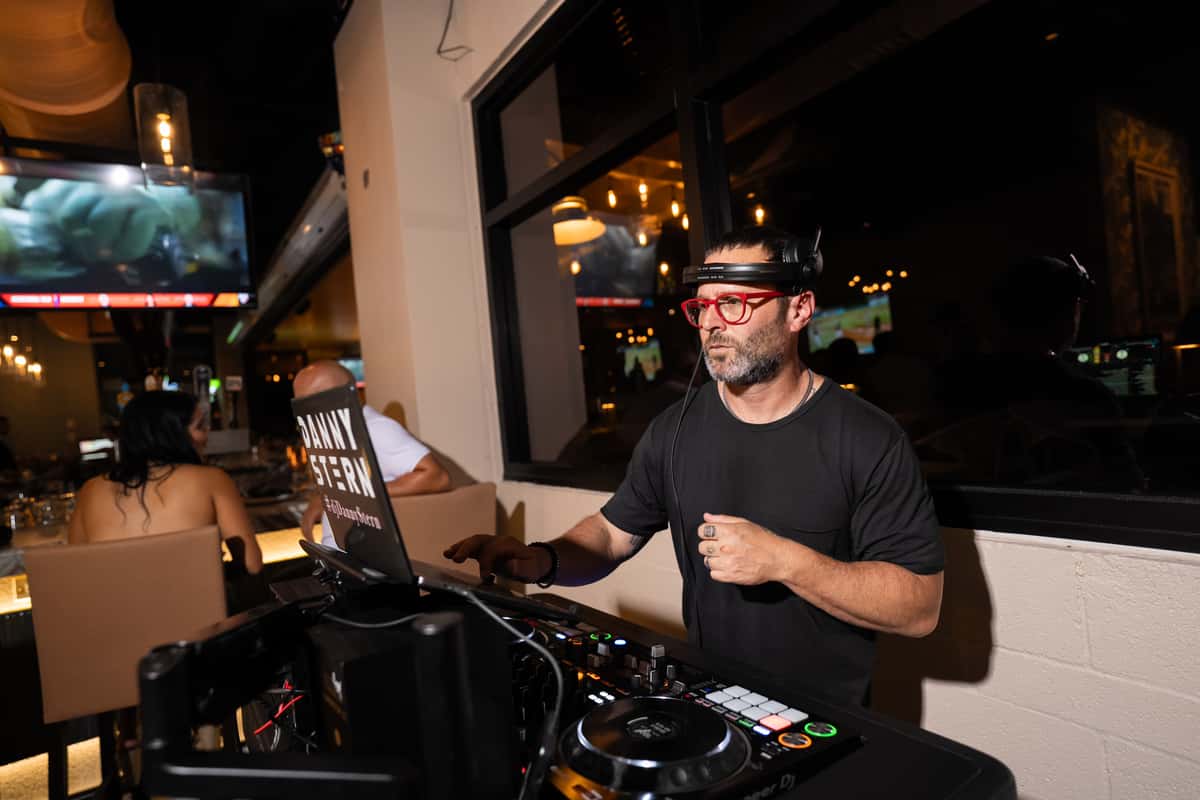 DJ standing behind a table working
