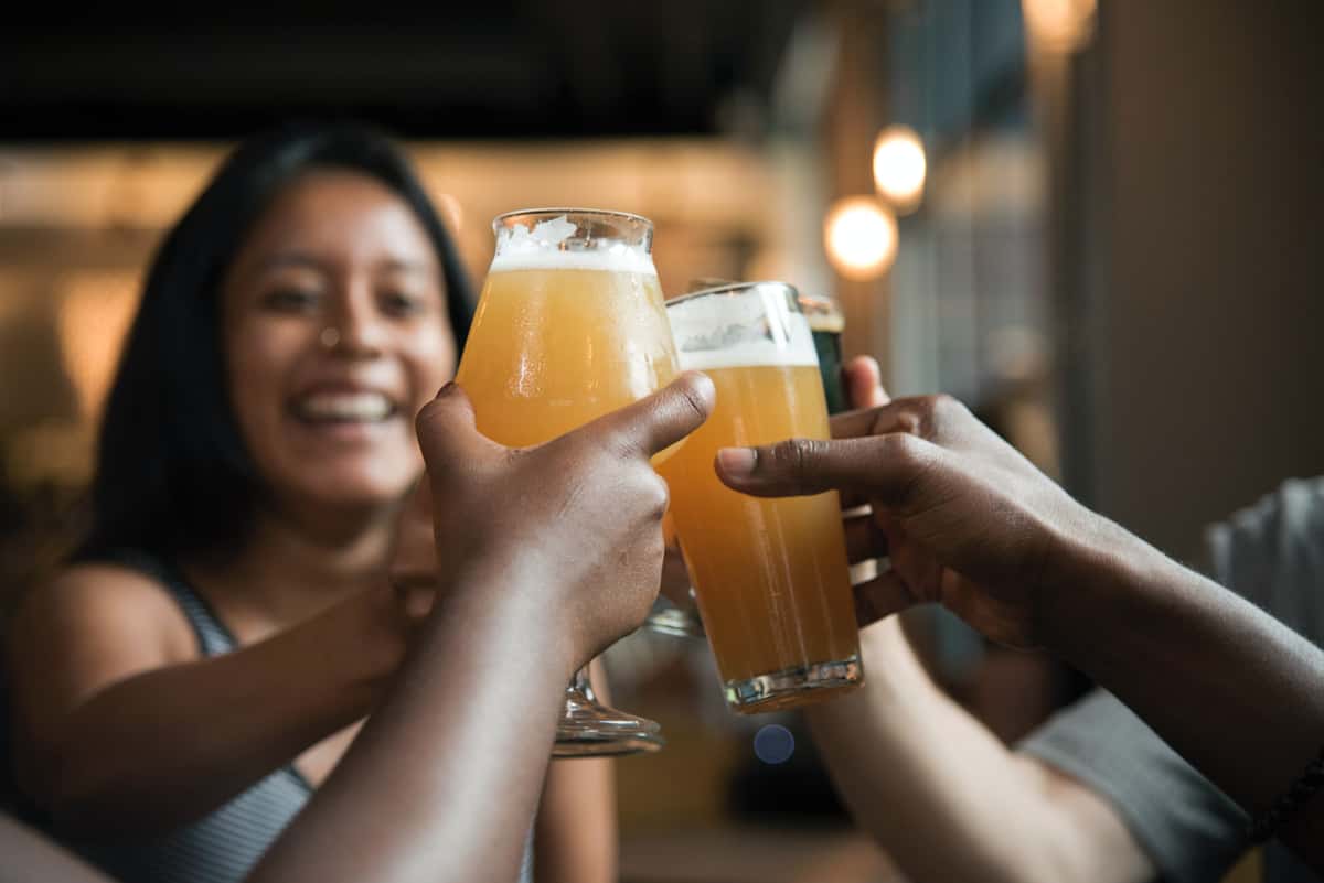 Guests toasting with full glasses of beer