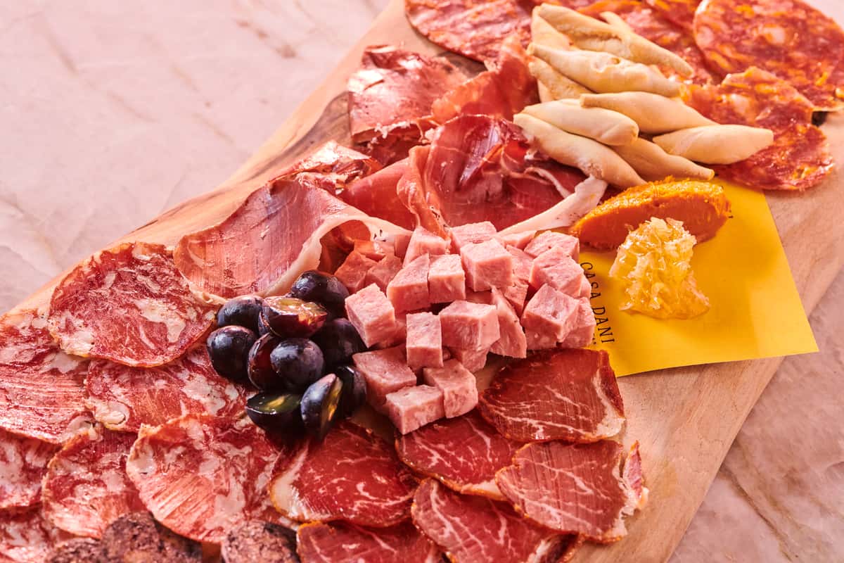 Charcuterie board with various meats and cheeses