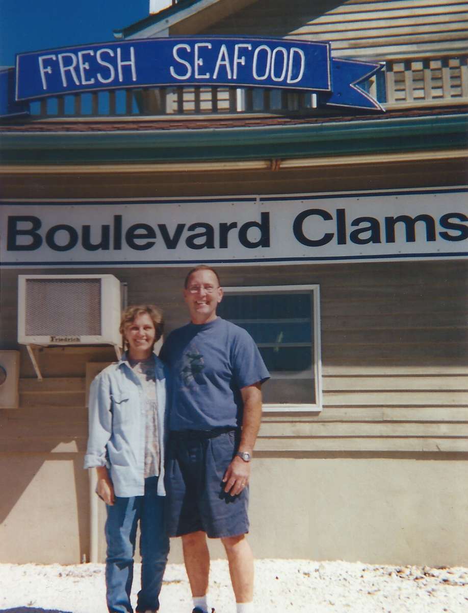 a couple standing in front of boulevard clams