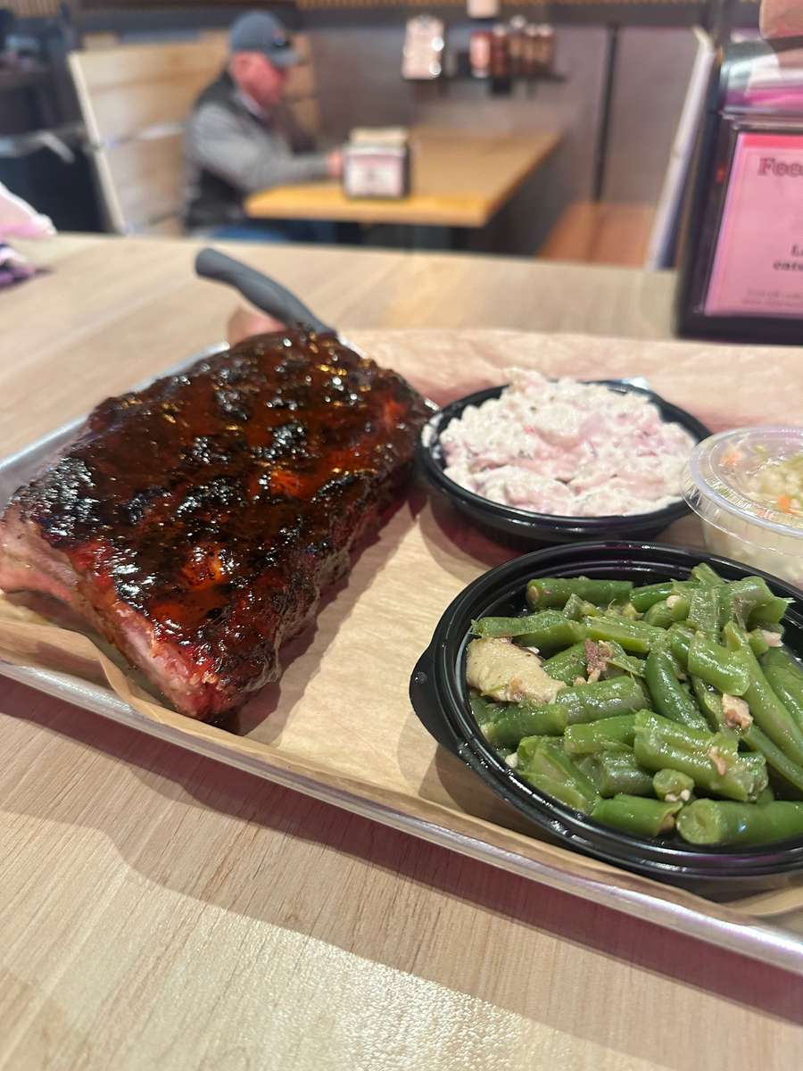 Half rack ribs sauced side green beans and potato salad