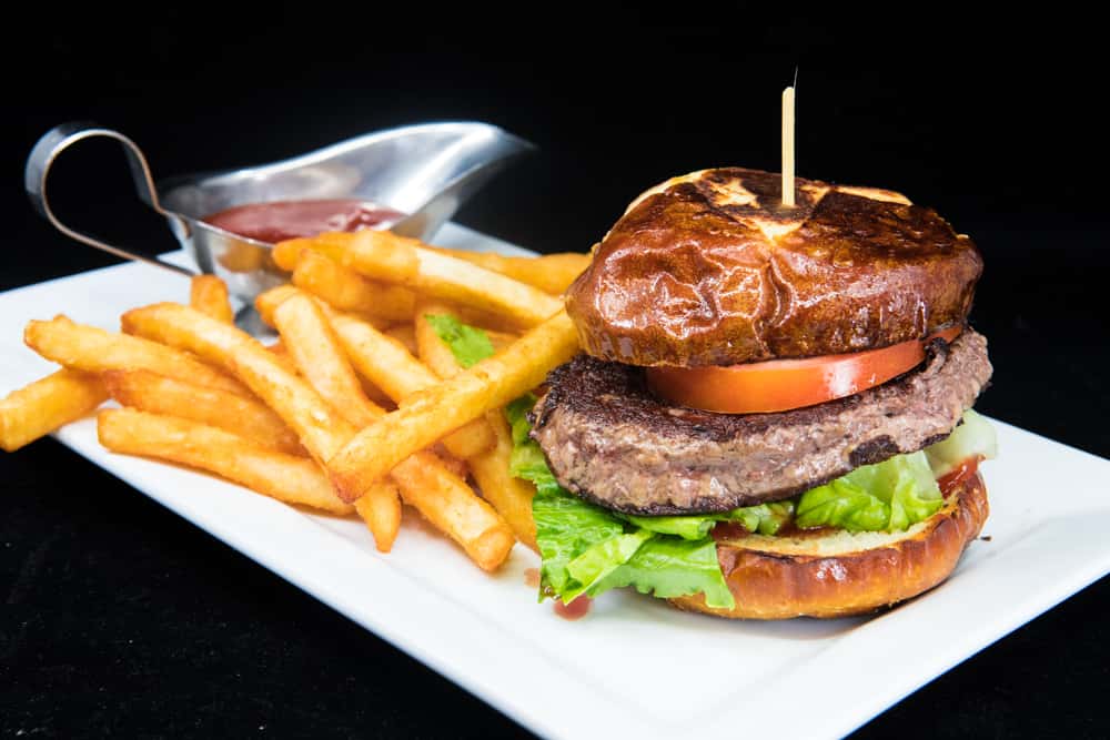 Burger served with fries and a sauce
