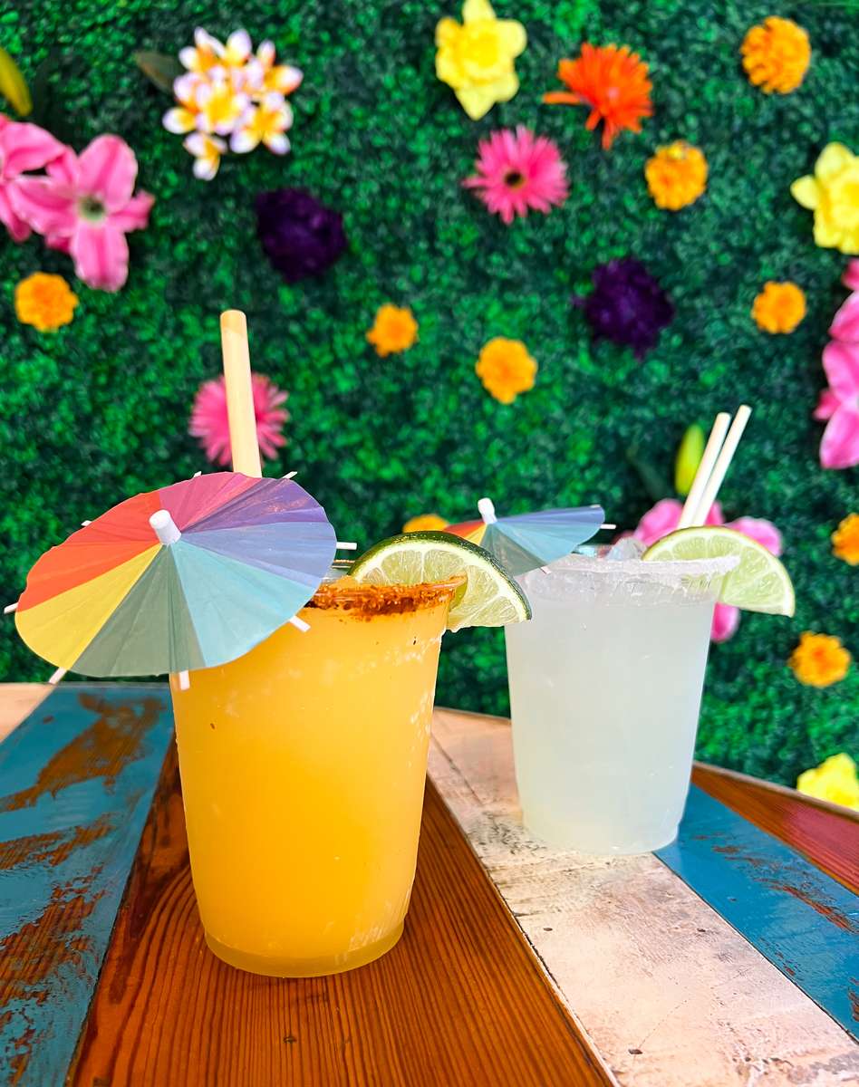 drinks in front of flower wall
