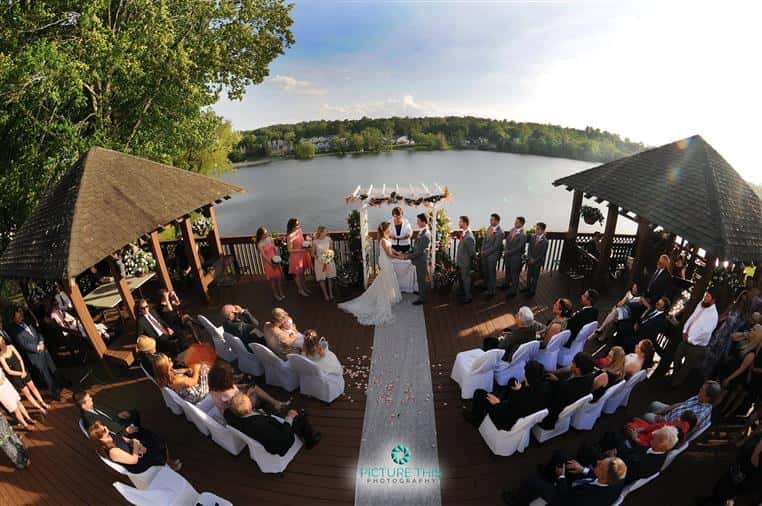 outside wedding with bride and groom with lake in background