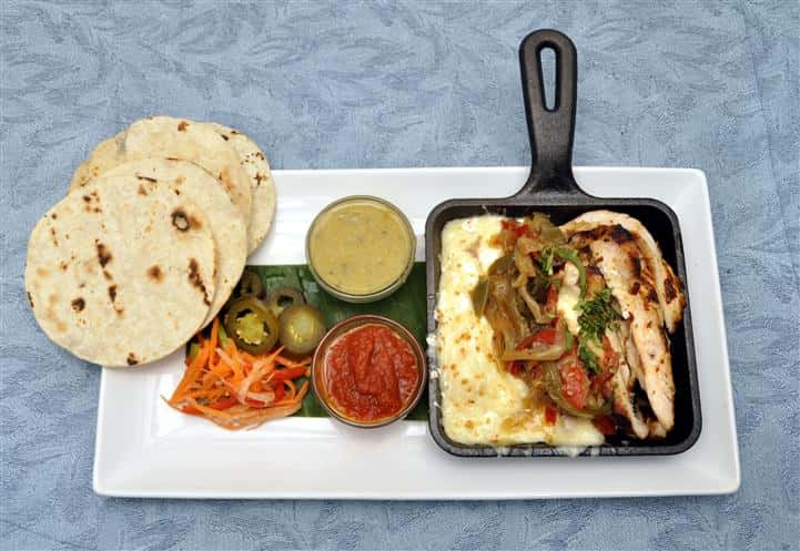 build your own taco with tortillas, jalapenos, sliced carrots, 2 different sauces, onions, chicken, and other toppings