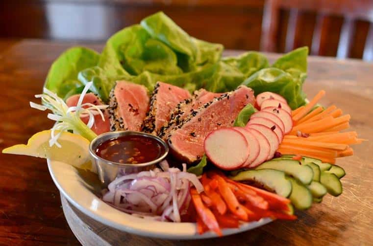 raw tuna over a salad