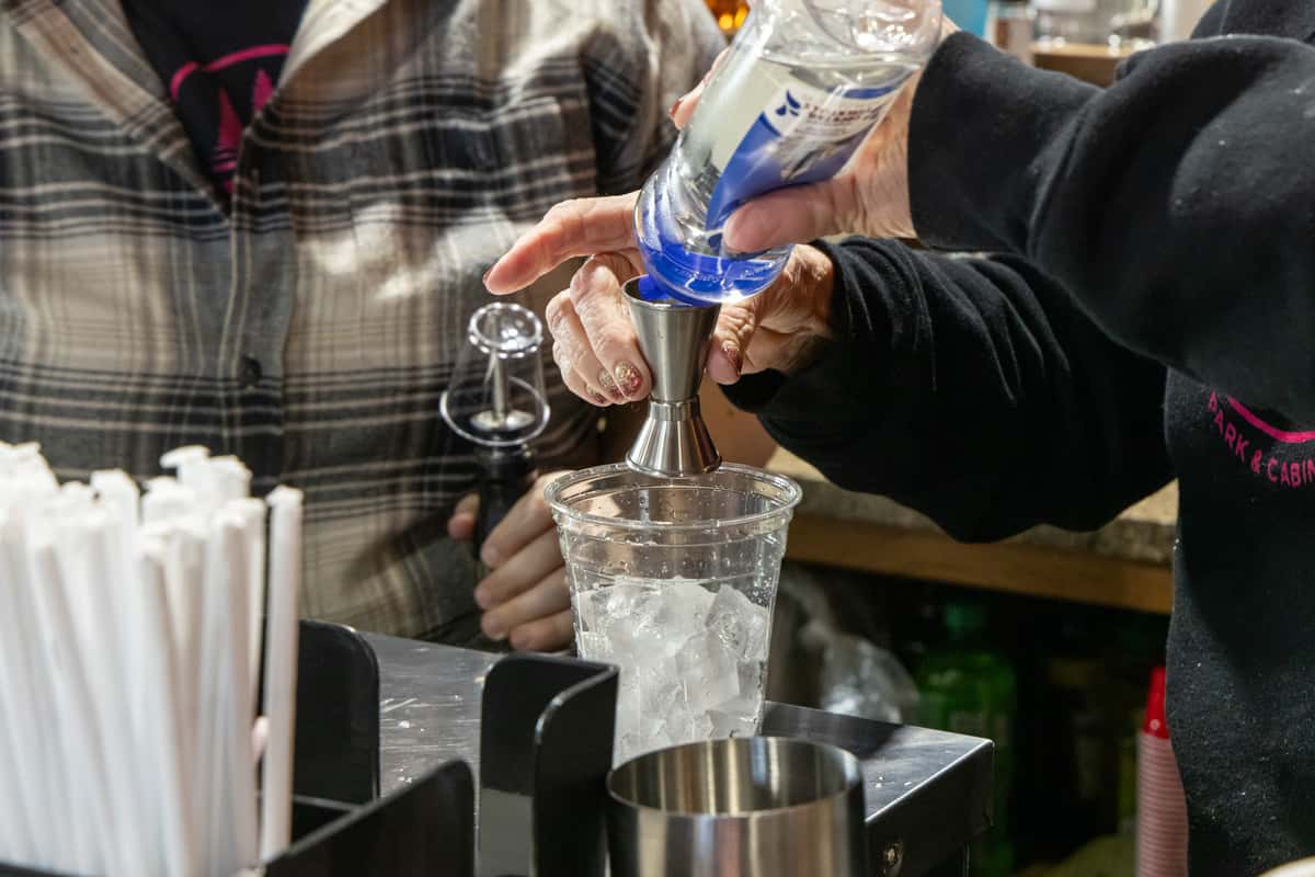 Person preparing a cocktail