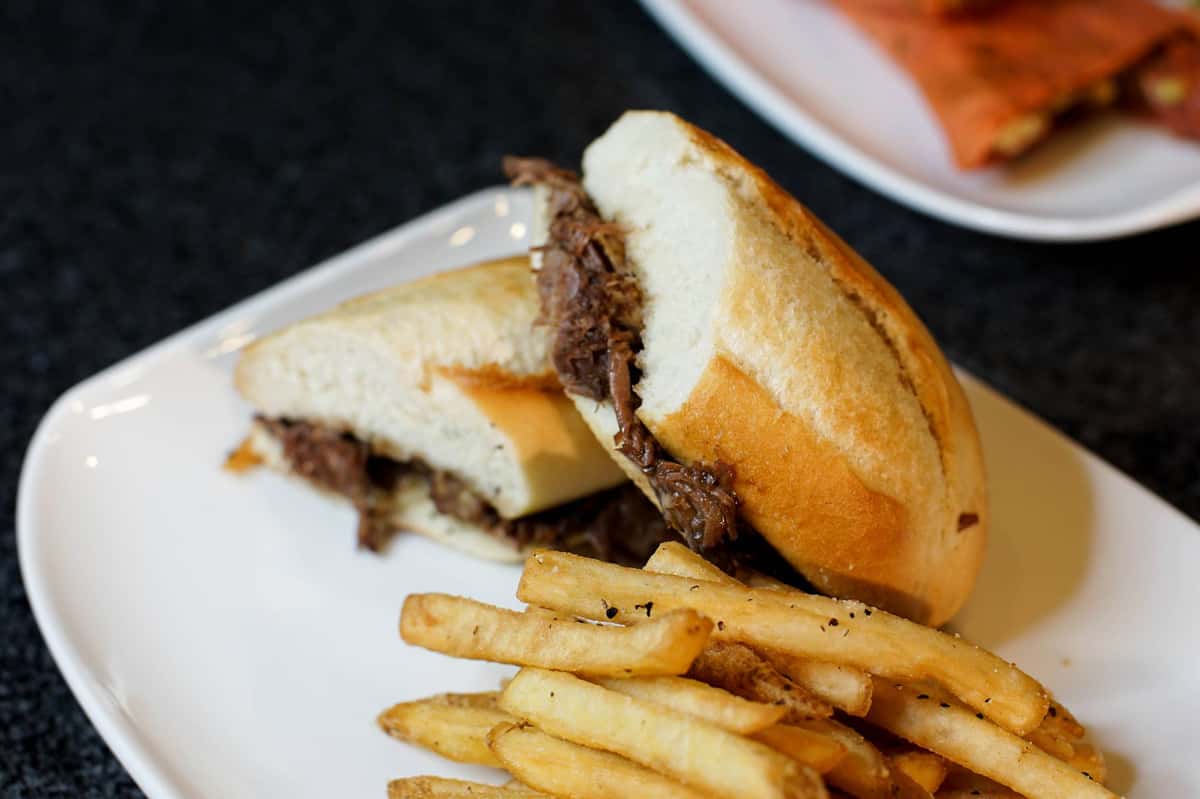 Steak sandwich on baguette with French fries