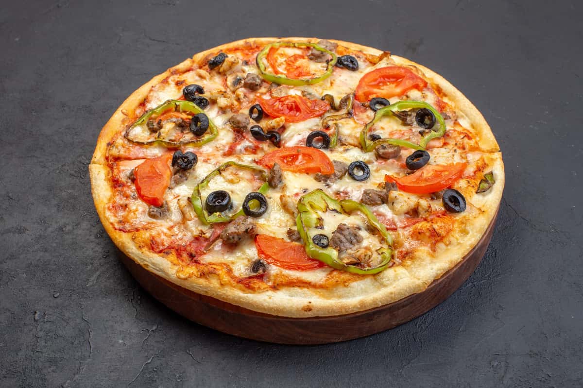 Front view delicious cheese pizza consists of olives pepper and tomatoes on dark surface.jpg