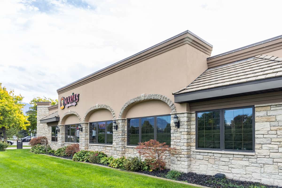 Exterior side view of Maria's Mexican Grill building and landscaped grounds