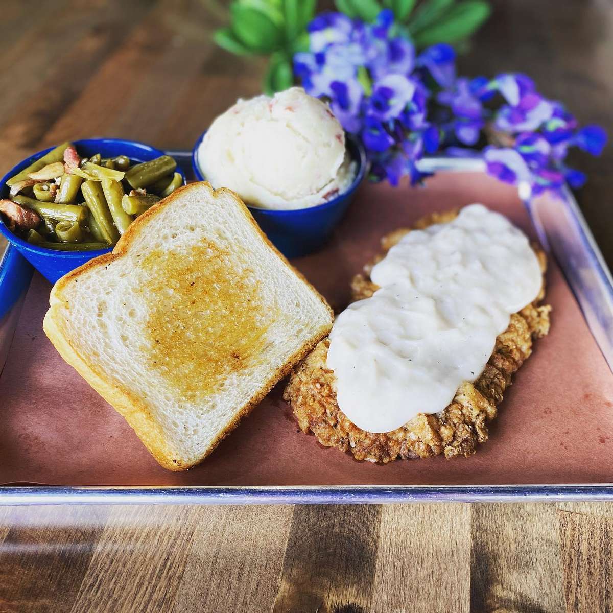 country fried steak with gravy and sides