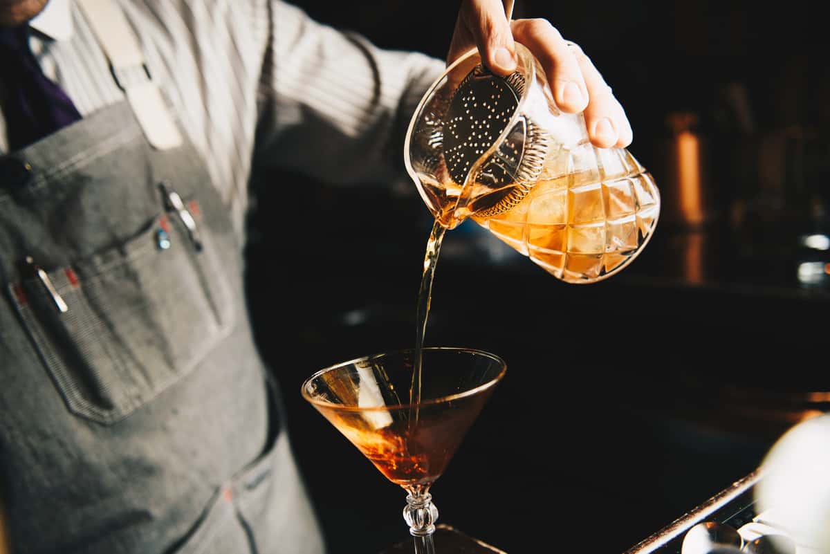 Bartender pouring a Sazerac