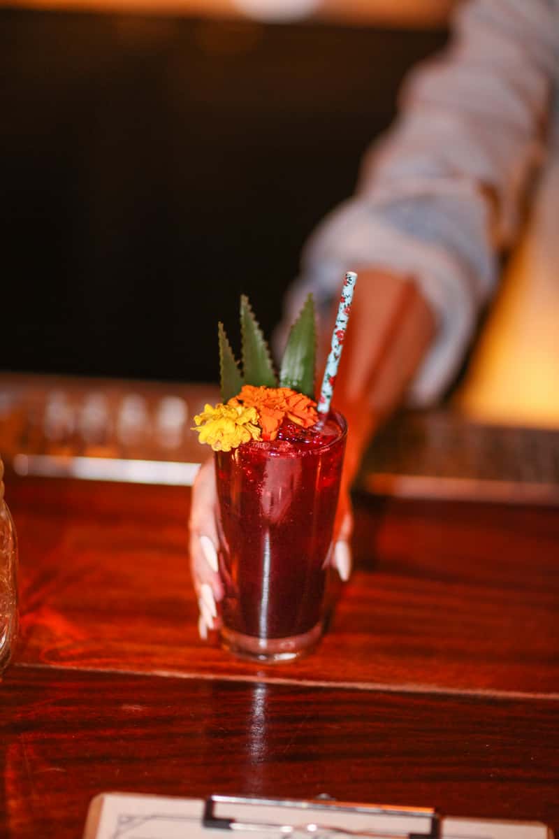 handing you a cocktail