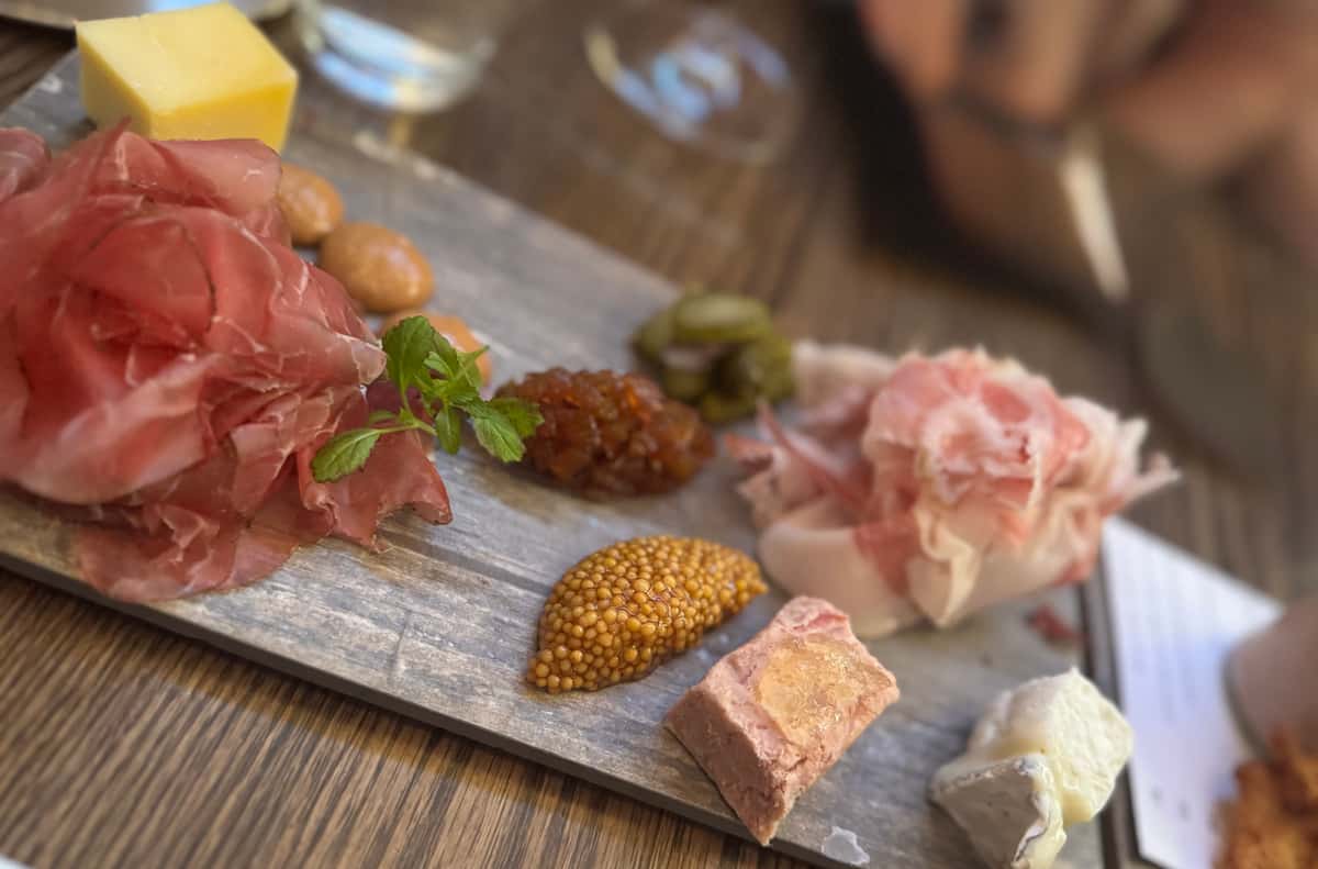 Grazing board with meat, cheeses, and condiments