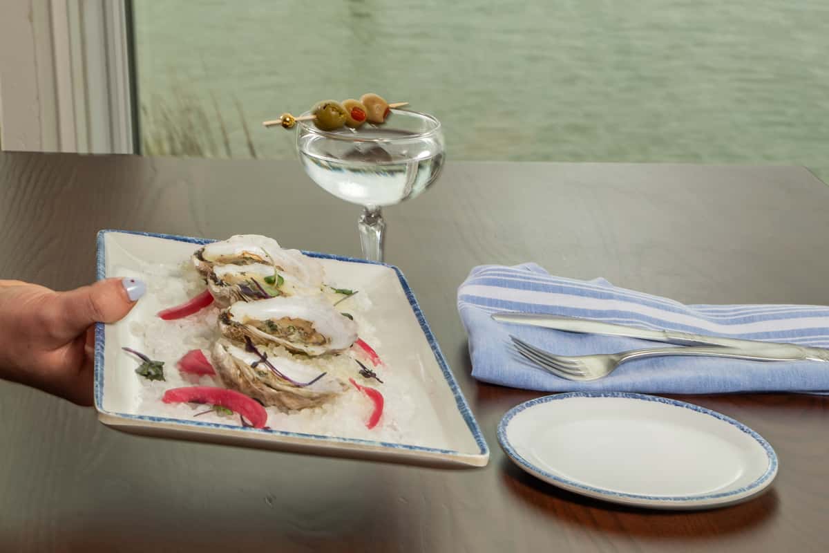 oysters on the half shell served with cocktail sauce and a chilled martini