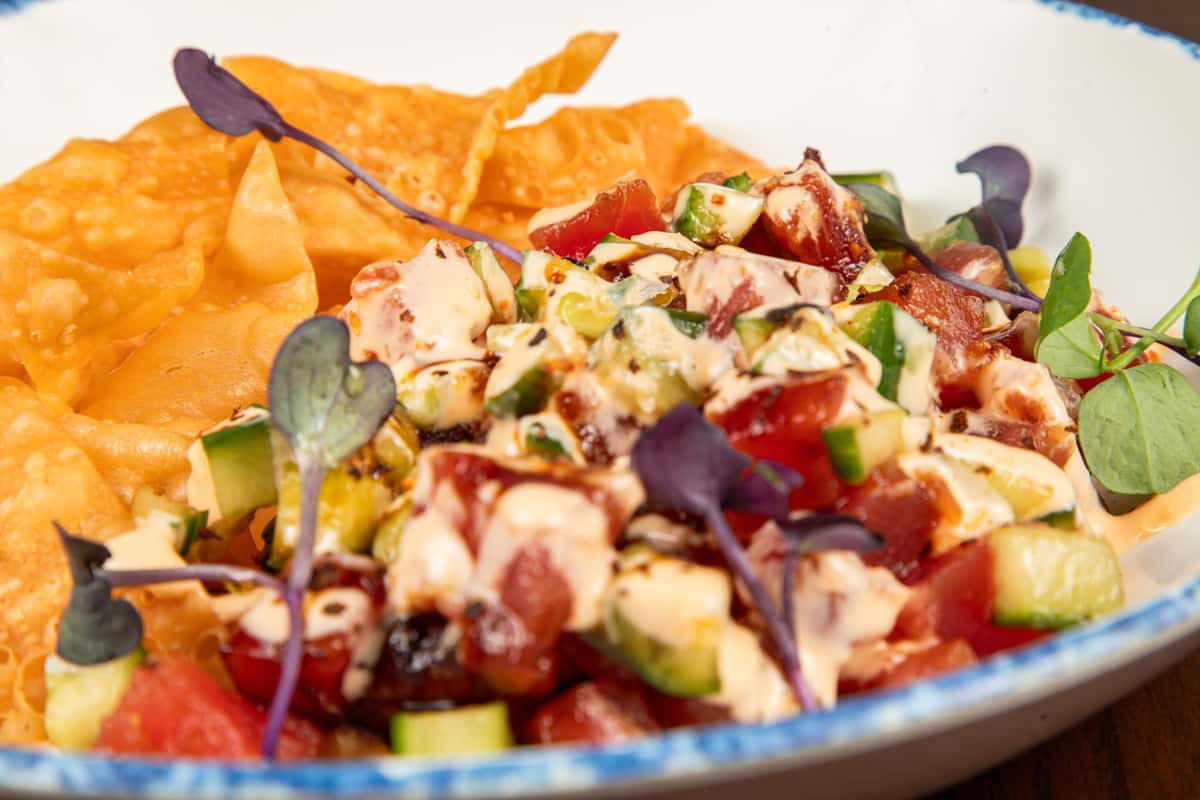 close-up of yellowfin tuna poke with diced tuna, avocado, and sesame seeds
