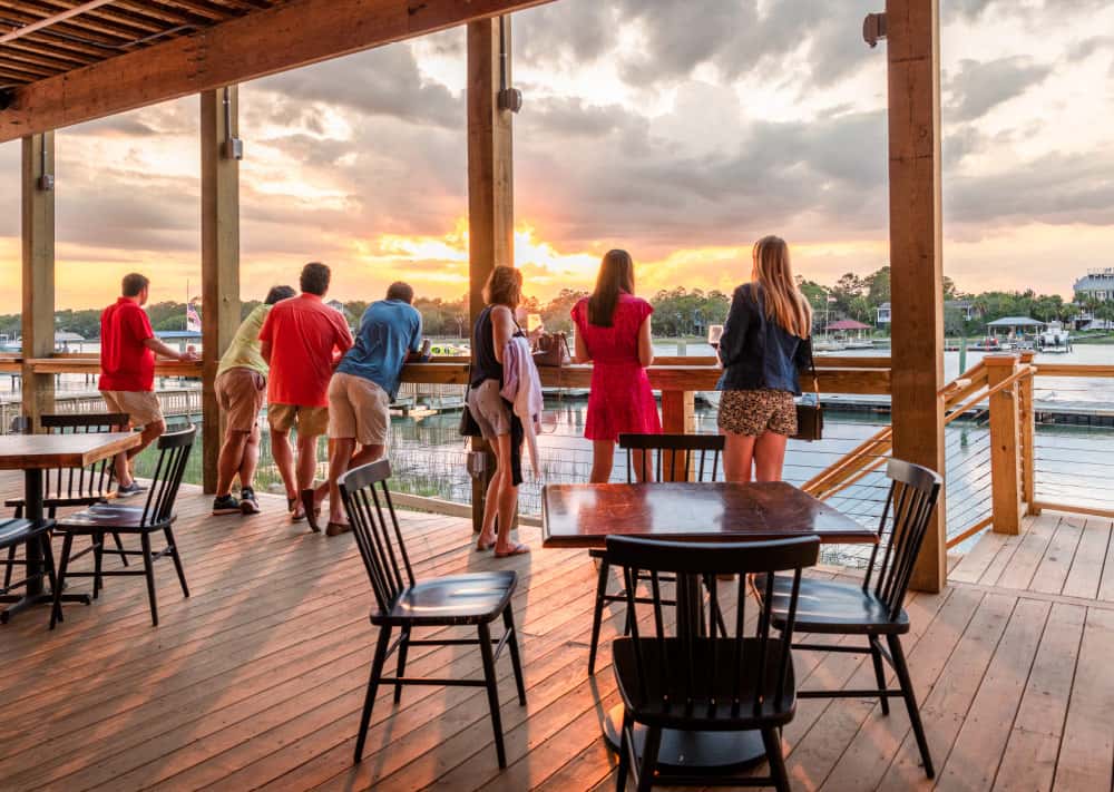 people enjoying bar area at sunset
