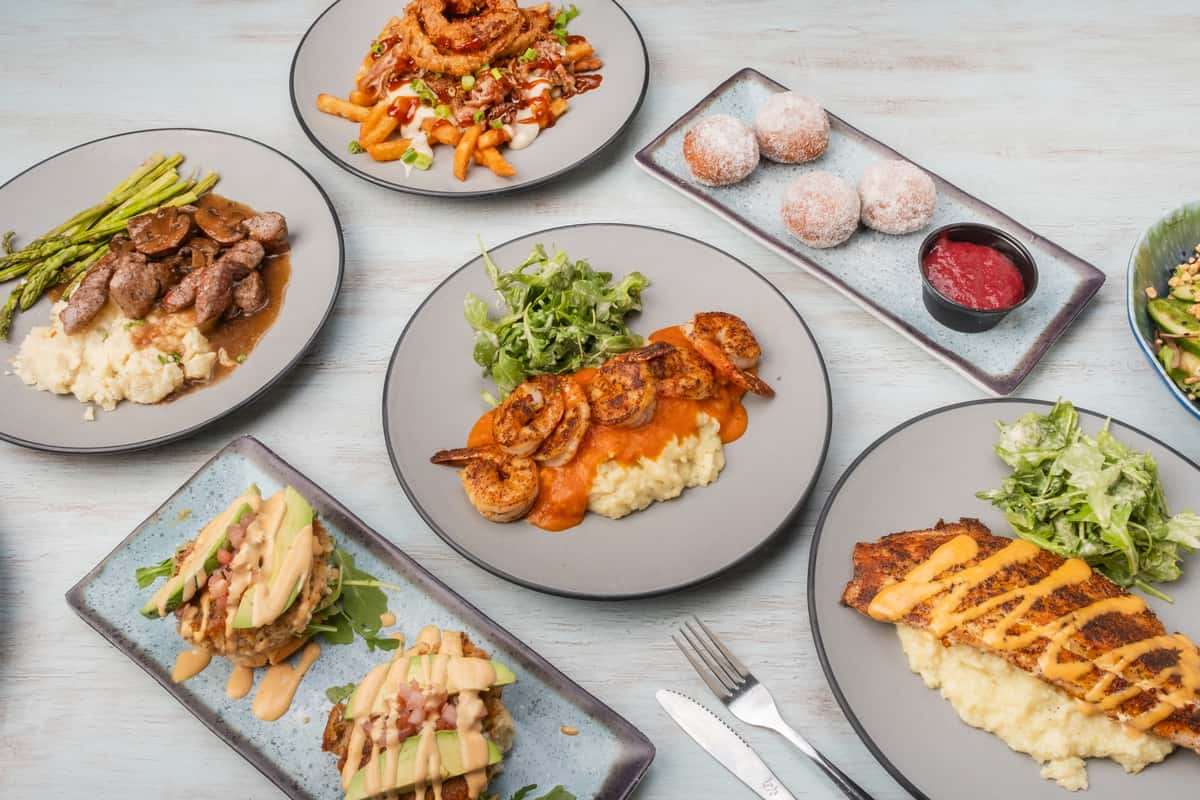 Scratch-made Southern comfort food and fresh coastal seafood favorites at Sharky's NSB, featuring signature entrees, sandwiches, and desserts in a laid-back beach bar on Flagler Avenue in New Smyrna Beach.