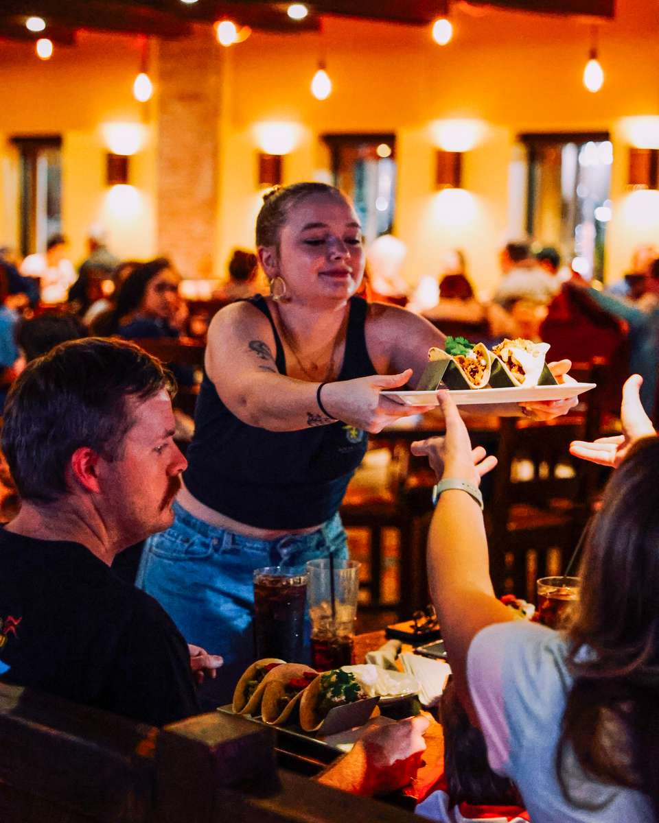 server handing food to customer