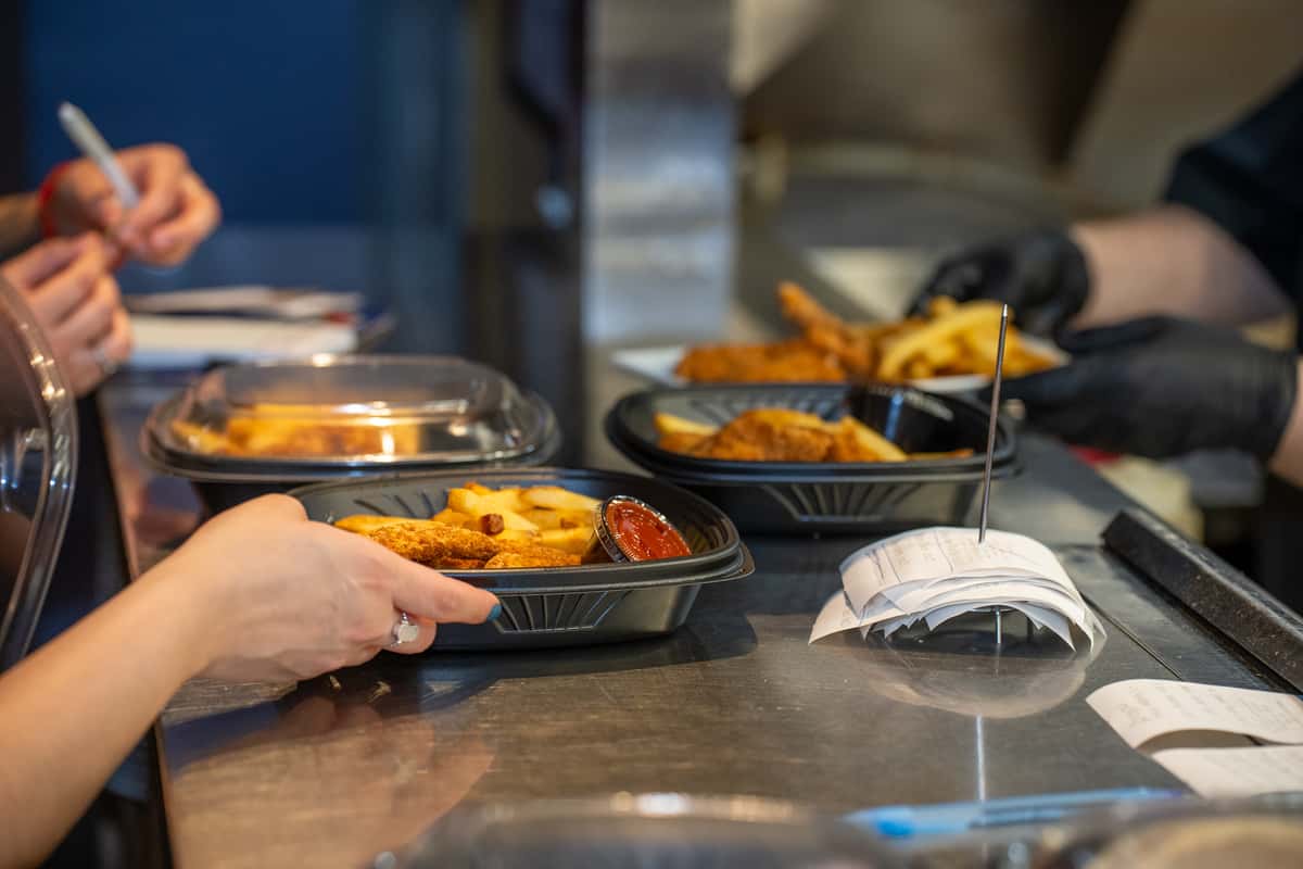Closeup of kitchen prep area where finished plates of food are ready for a waitress to pick up