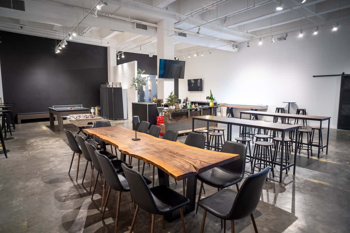 Modern private event space at Hardwood Bar & Smokery with long communal tables, contemporary seating, and room for meetings and special occasions