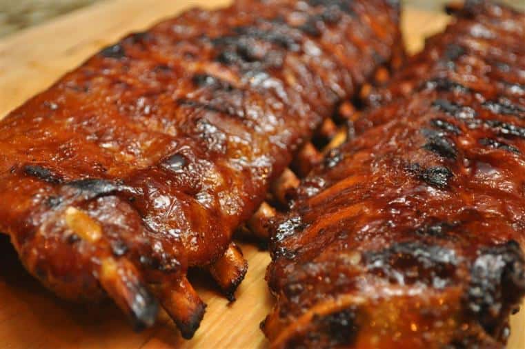 baby back ribs displayed on a wooden counter 