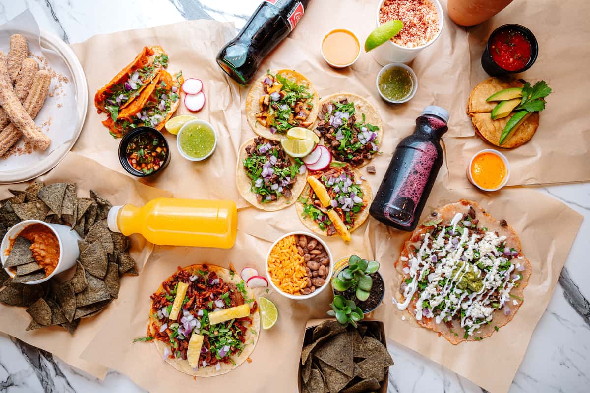 Overhead shot of Buckeheads favorite assorted tacos, quesadillas, sides, drinks, and Birria!