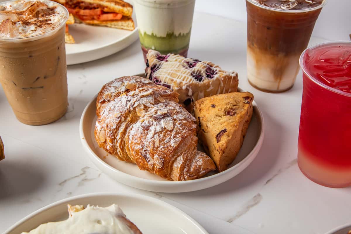 Baked goods on a plate featuring the signature almond croissant