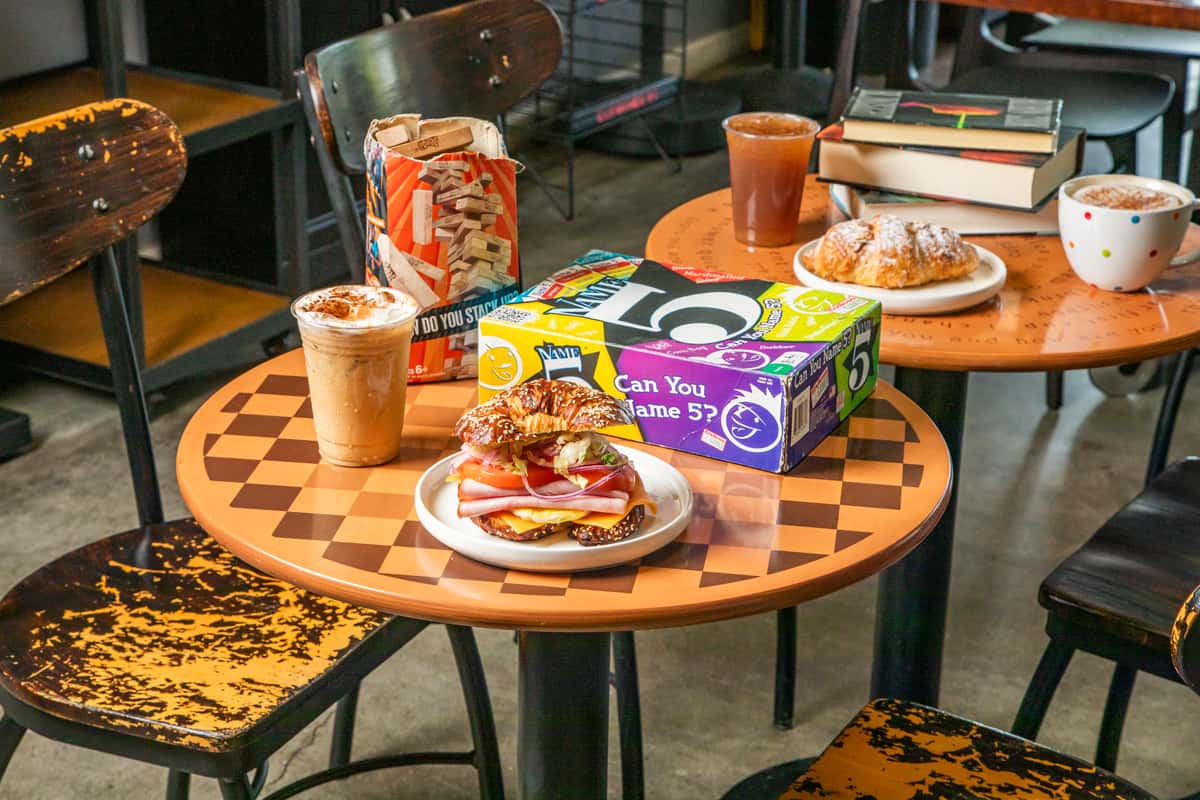 Cafe table filled with a variety of food and drinks